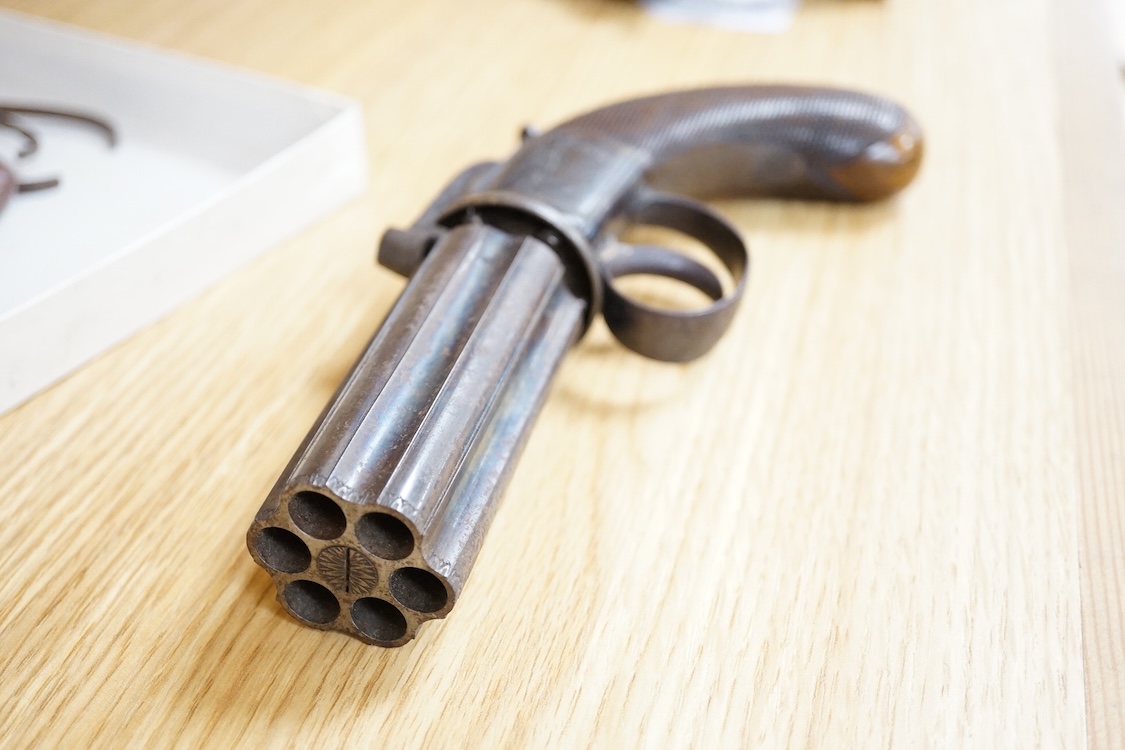 A six shot 80 bore, self-cocking, pepperbox revolver signed; W. Dooley, Liverpool, with foliate engraved frame and fluted barrel, Birmingham proved, and one piece rounded chequered walnut grip, together with a small copp